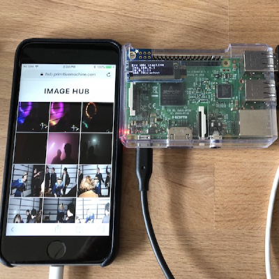 iphone showing gallery app next to raspberry pi